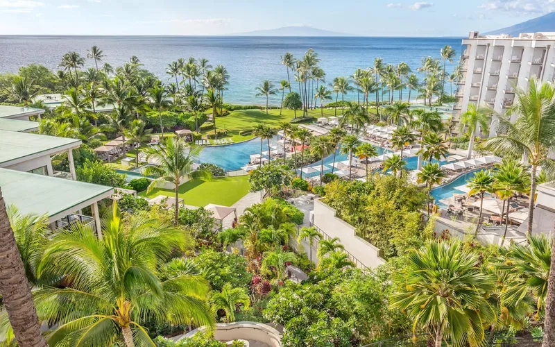 Terraced pools and palm trees above the ocean at Andaz Maui at Wailea Resort